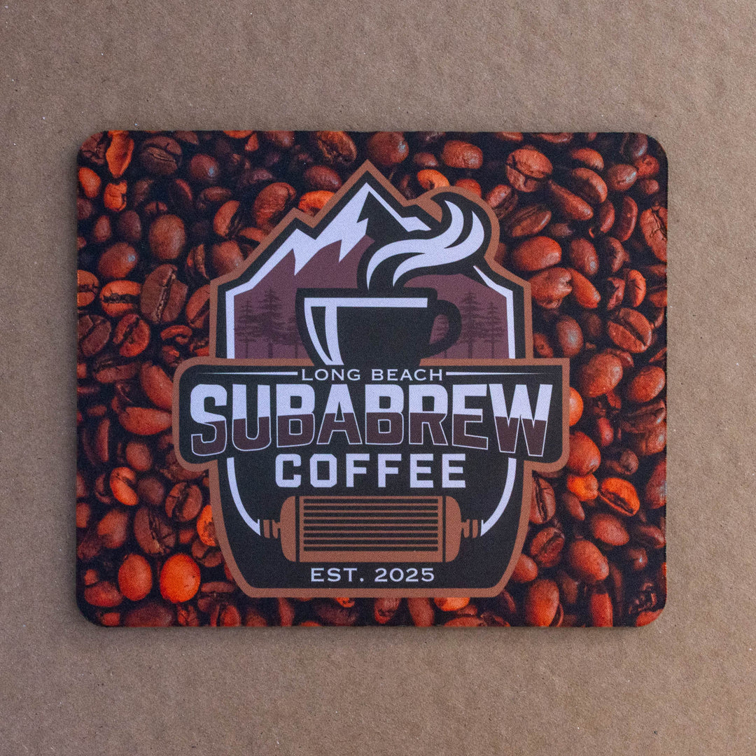 A square mouse pad featuring a coffee-themed design with a central &