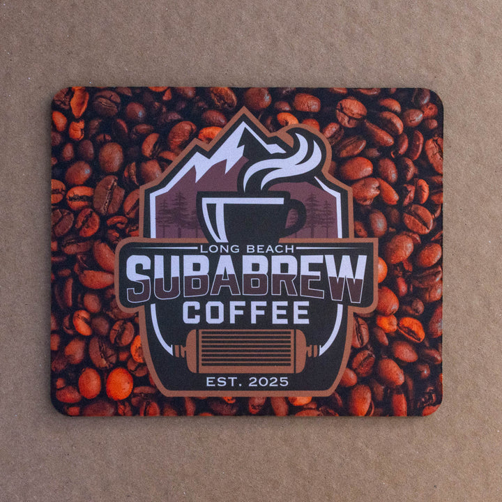 A square mouse pad featuring a coffee-themed design with a central &